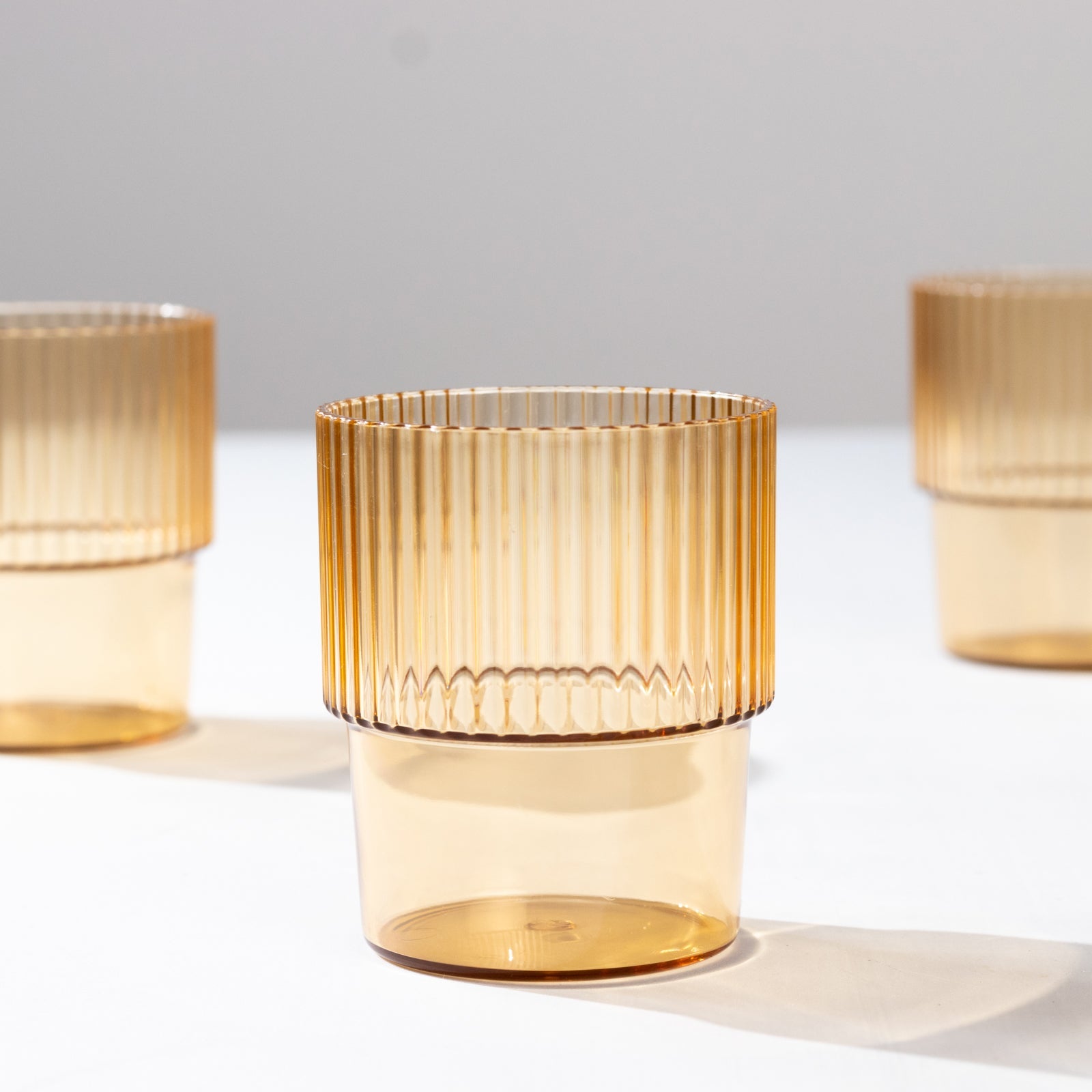 12-Piece Set of Reusable 7oz Stackable Amber Gold Plastic Drinking Glasses with Ribbed Pattern