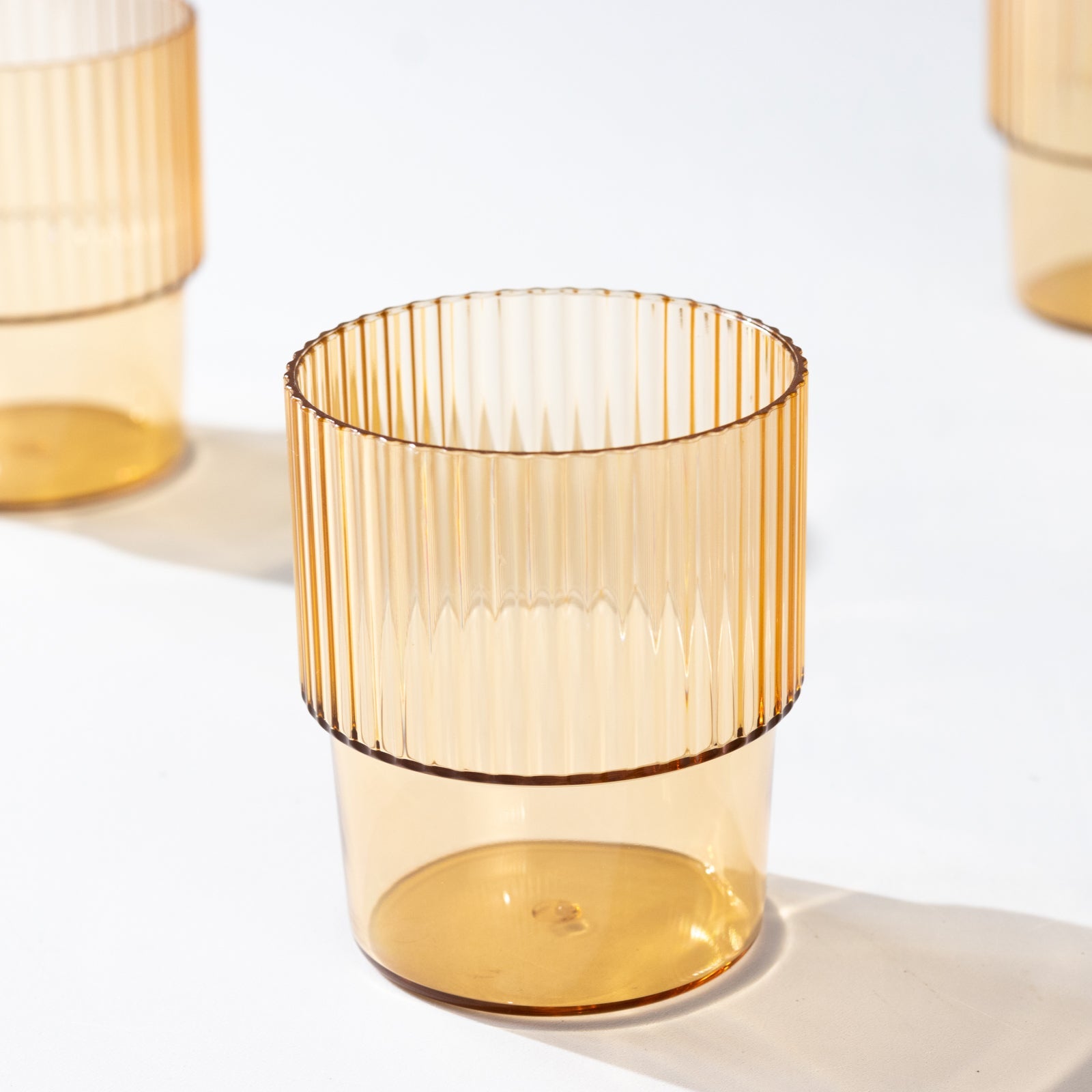 12-Piece Set of Reusable 7oz Stackable Amber Gold Plastic Drinking Glasses with Ribbed Pattern