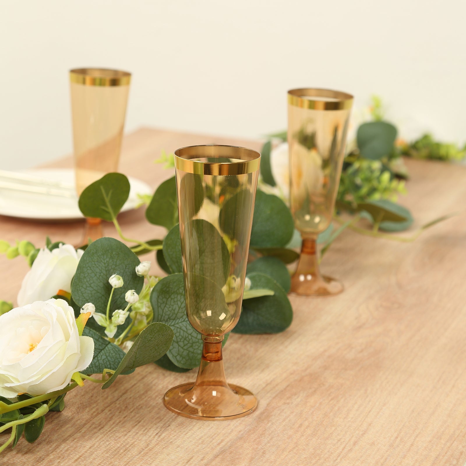 Stylish Disposable 5oz Plastic Champagne Flutes in Transparent Amber Gold with Gold Rim - 12-Pack for Parties
